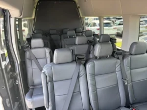 mrchauffeurcolorado | Spacious interior of a modern passenger van with gray leather seats, ideal for group travel or shuttle services