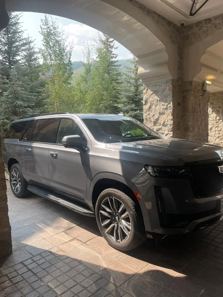 Luxury Cadillac Escalade SUV parked at mountain resort — premium private shuttle and airport transfer service