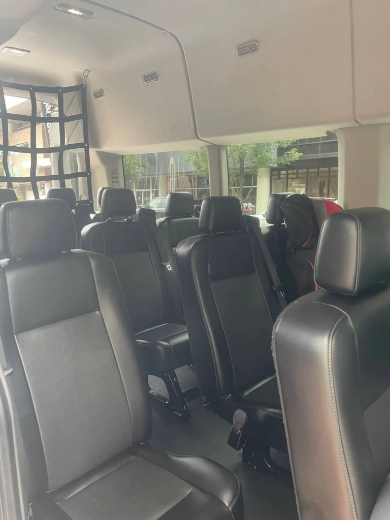 Spacious and comfortable interior of private shuttle van with black leather seats — ideal for airport transfers, group transportation, and executive travel in Aspen and Vail