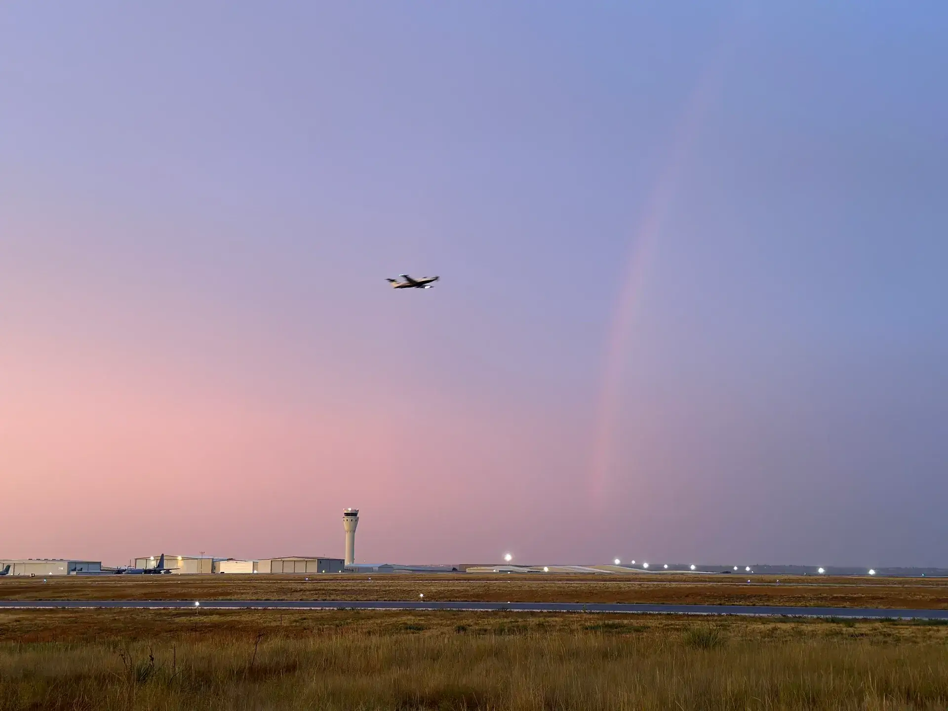 Centennial Airport at sunset with airplane taking off, private airport car service to Colorado ski resorts