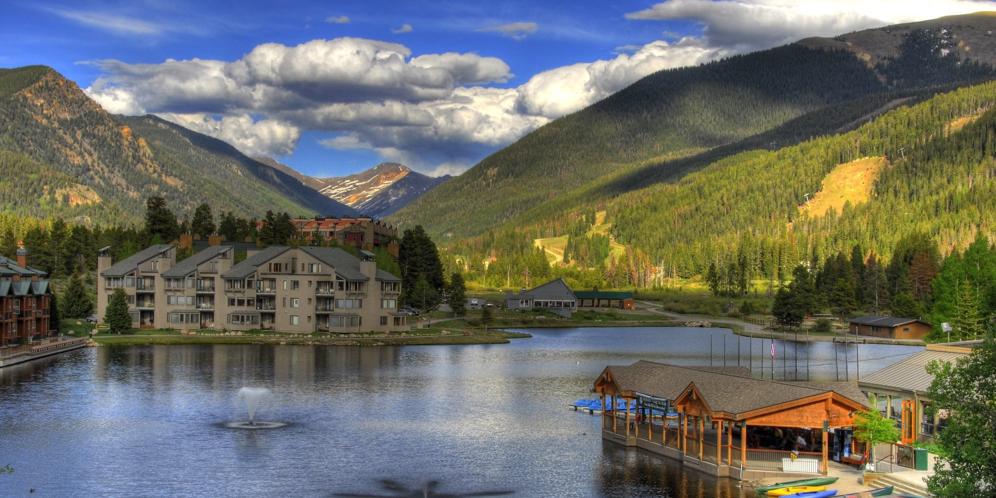 Scenic view of Keystone, Colorado with lakefront lodges and mountain backdrop in summer