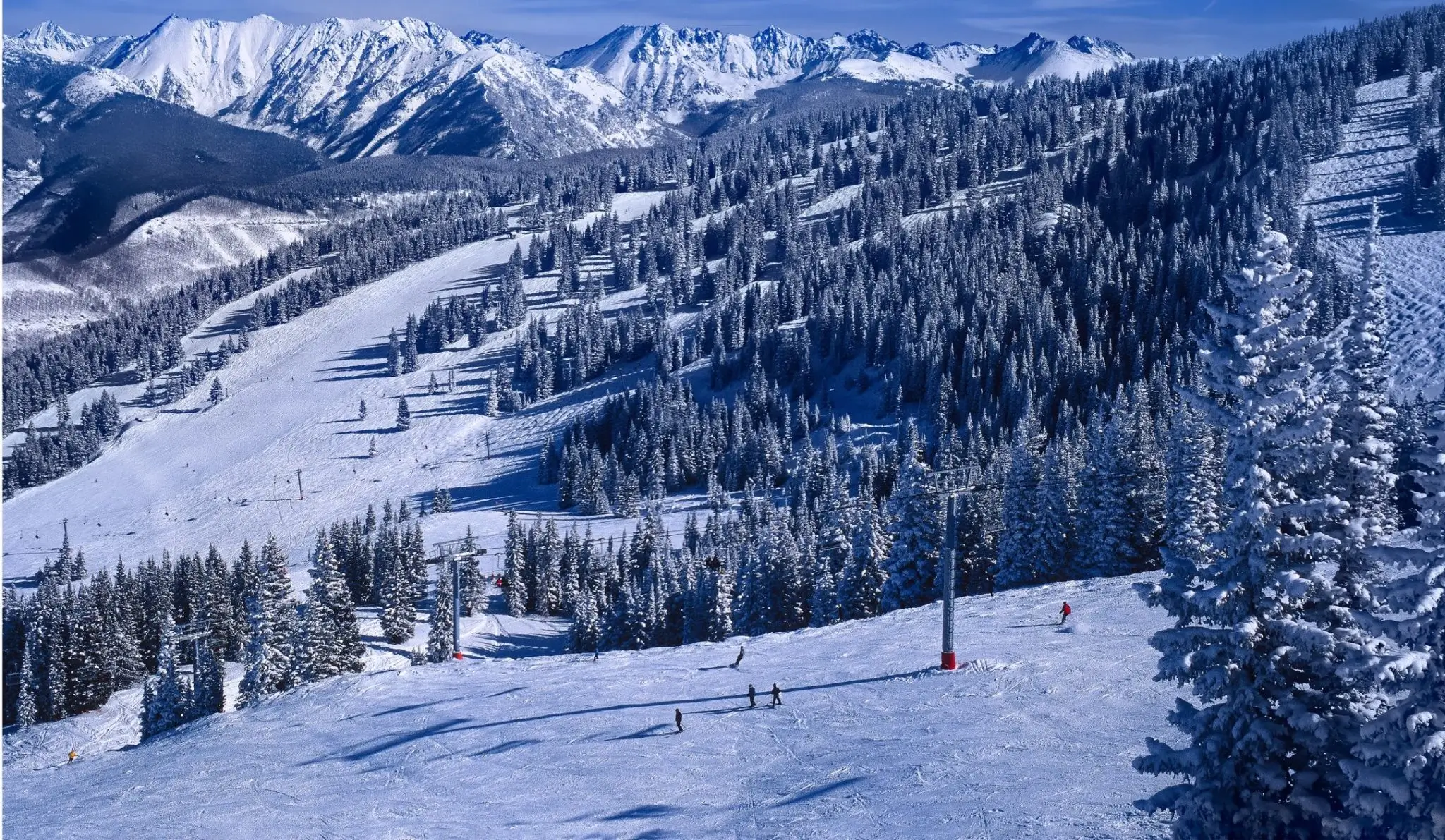 Snow-covered ski slopes and mountain peaks in Vail, Colorado - private shuttle service and group transportation to Vail ski resort.
