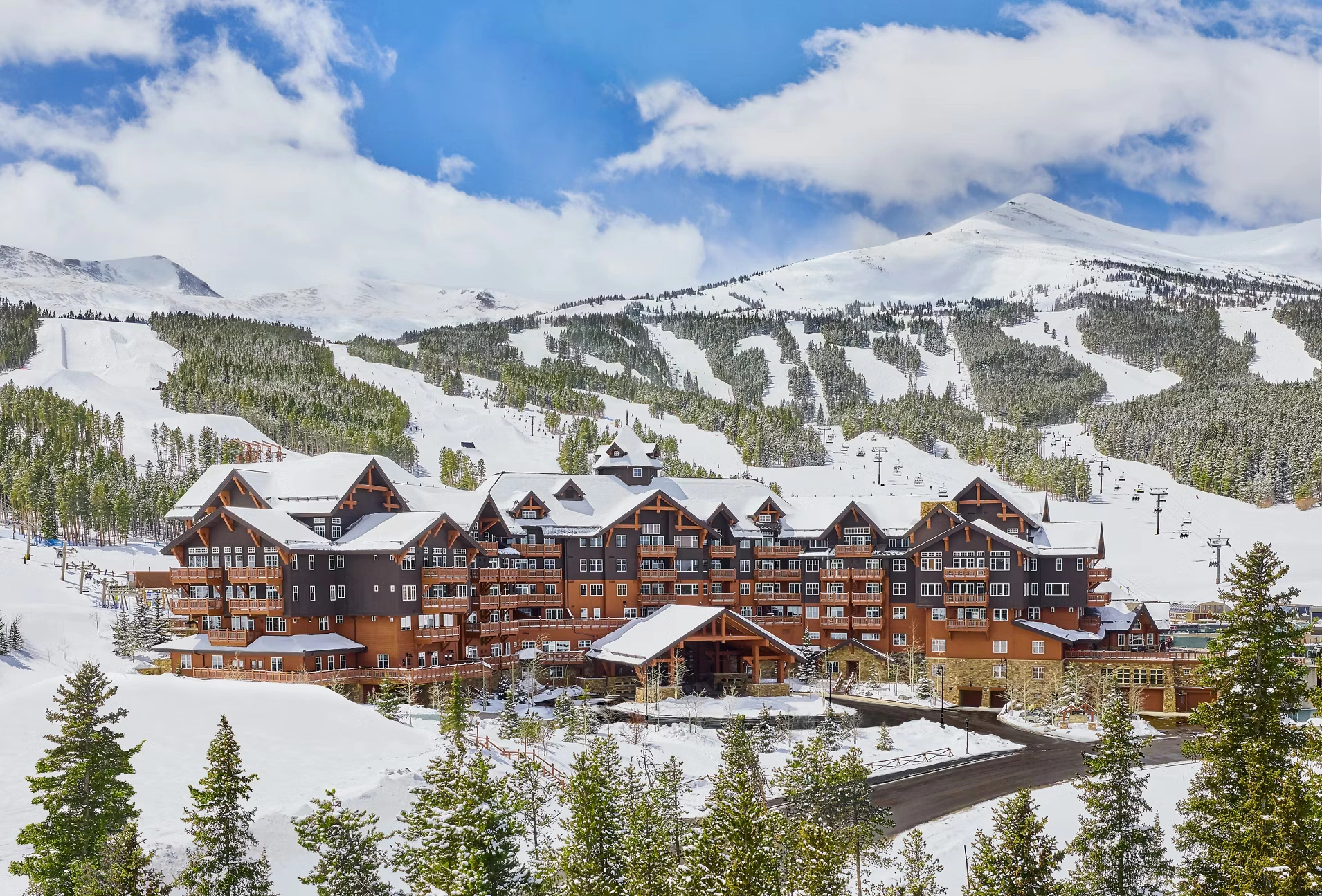 Luxury shuttle service driving through snowy Colorado mountains with professional private transportation