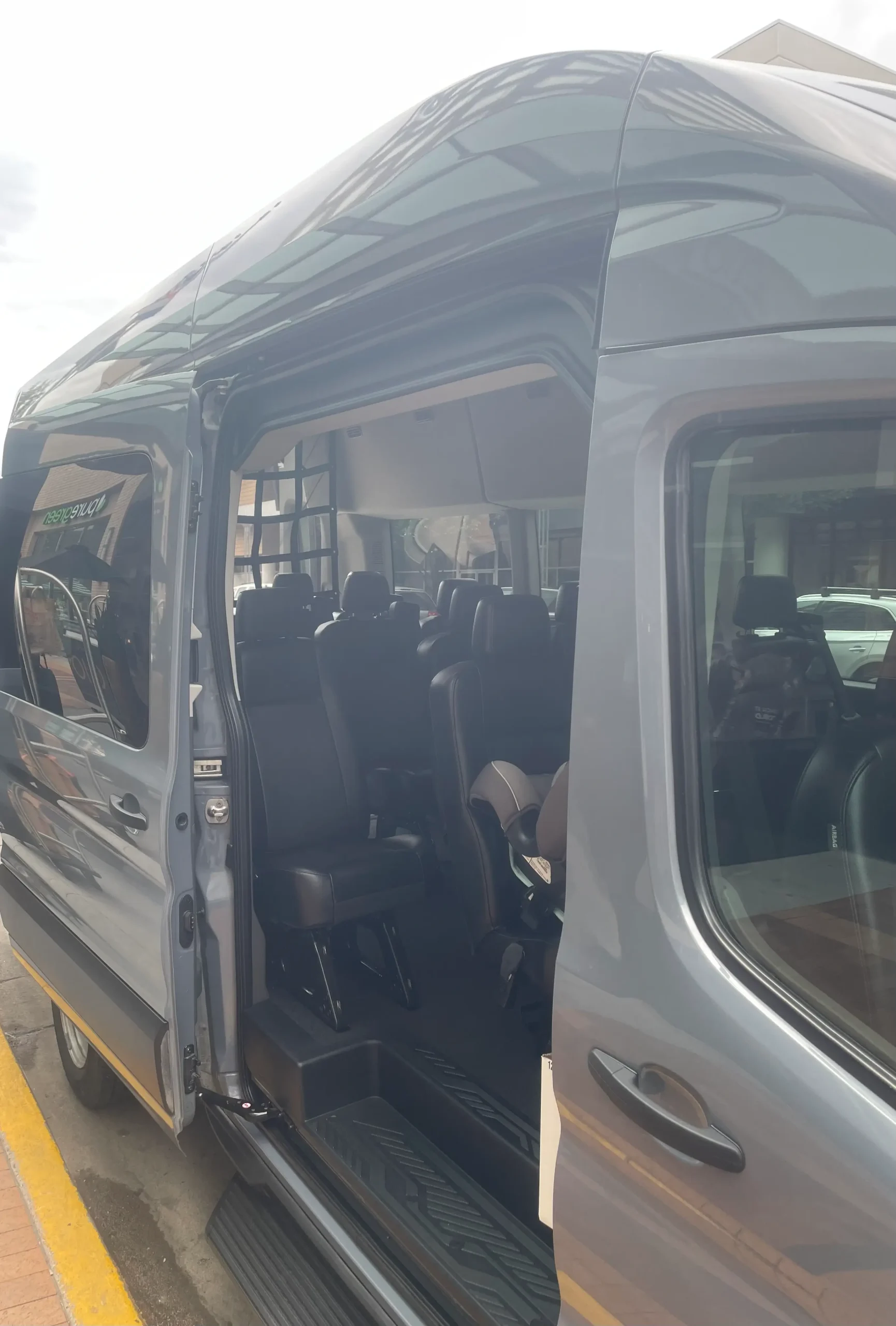 Luxury airport shuttle van interior with open door. Private group transportation service by Mr. Chauffeur Colorado.