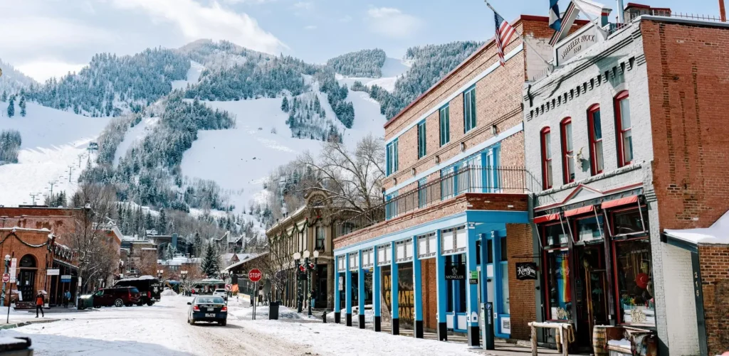 Snowy downtown Aspen street and mountain views. Private shuttle to Aspen by Mr. Chauffeur Colorado.