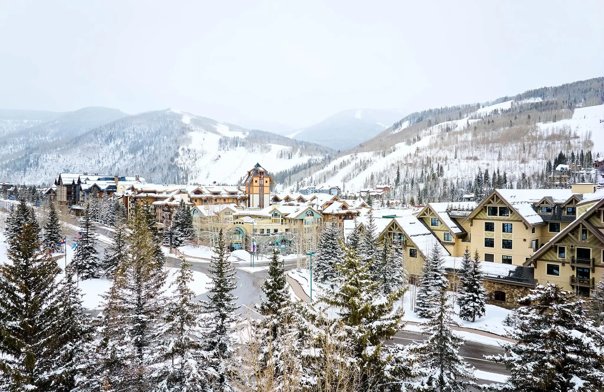 Snowy Vail Village and ski resort slopes. Private car service to Vail by Mr. Chauffeur Colorado.