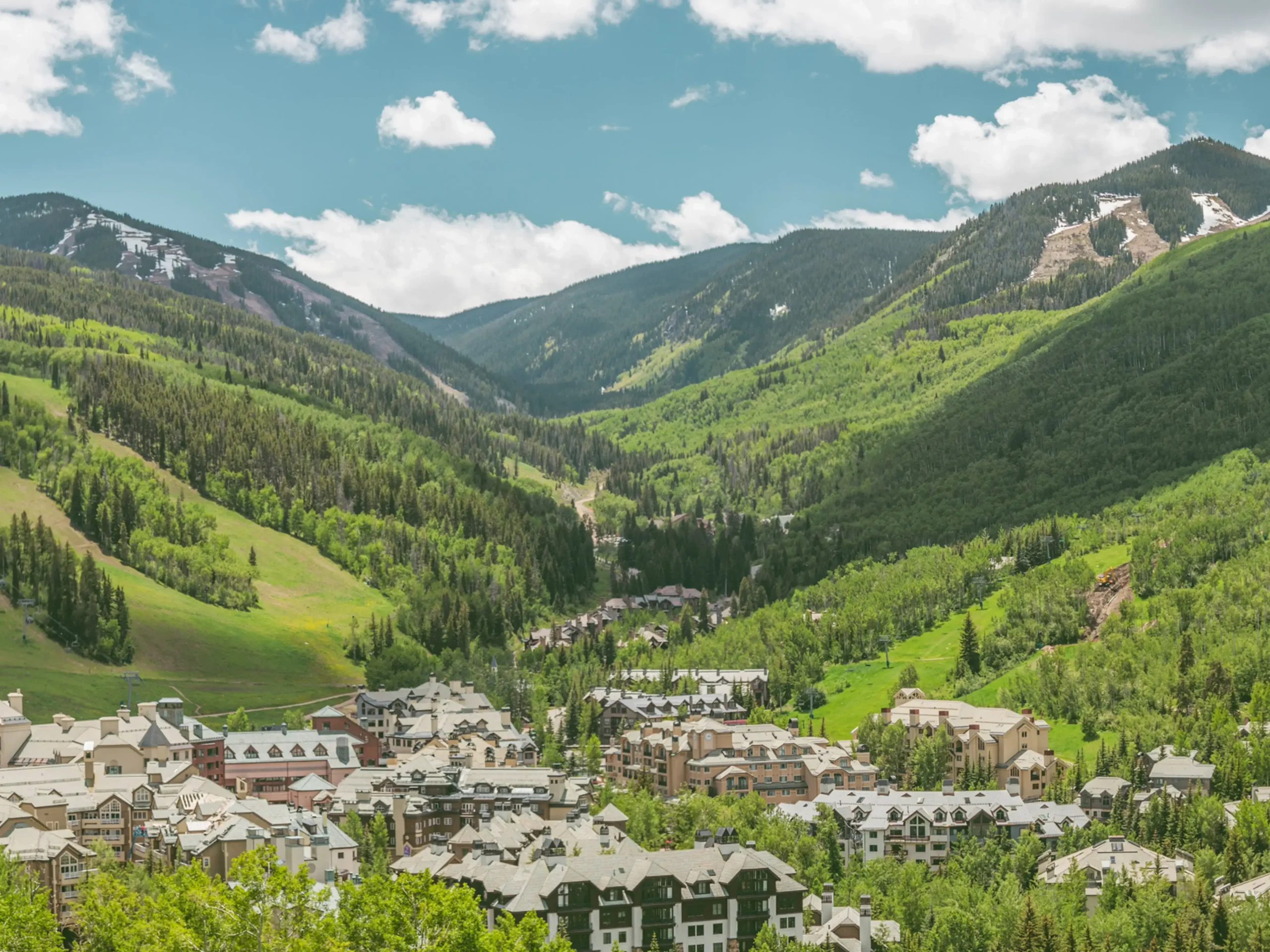 Summer view of Beaver Creek village and mountains. Private luxury mountain shuttle to Beaver Creek by Mr. Chauffeur Colorado.