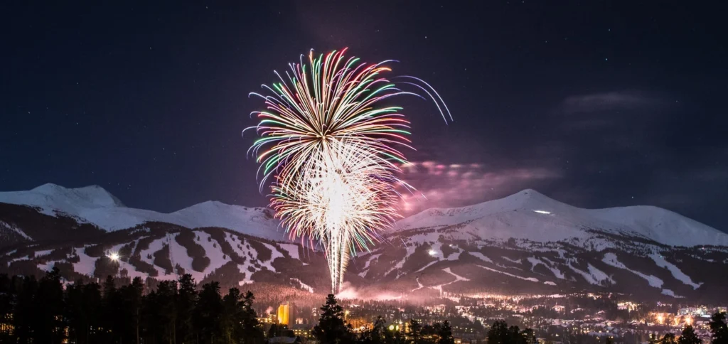 Fireworks display over Breckenridge ski resort at night.