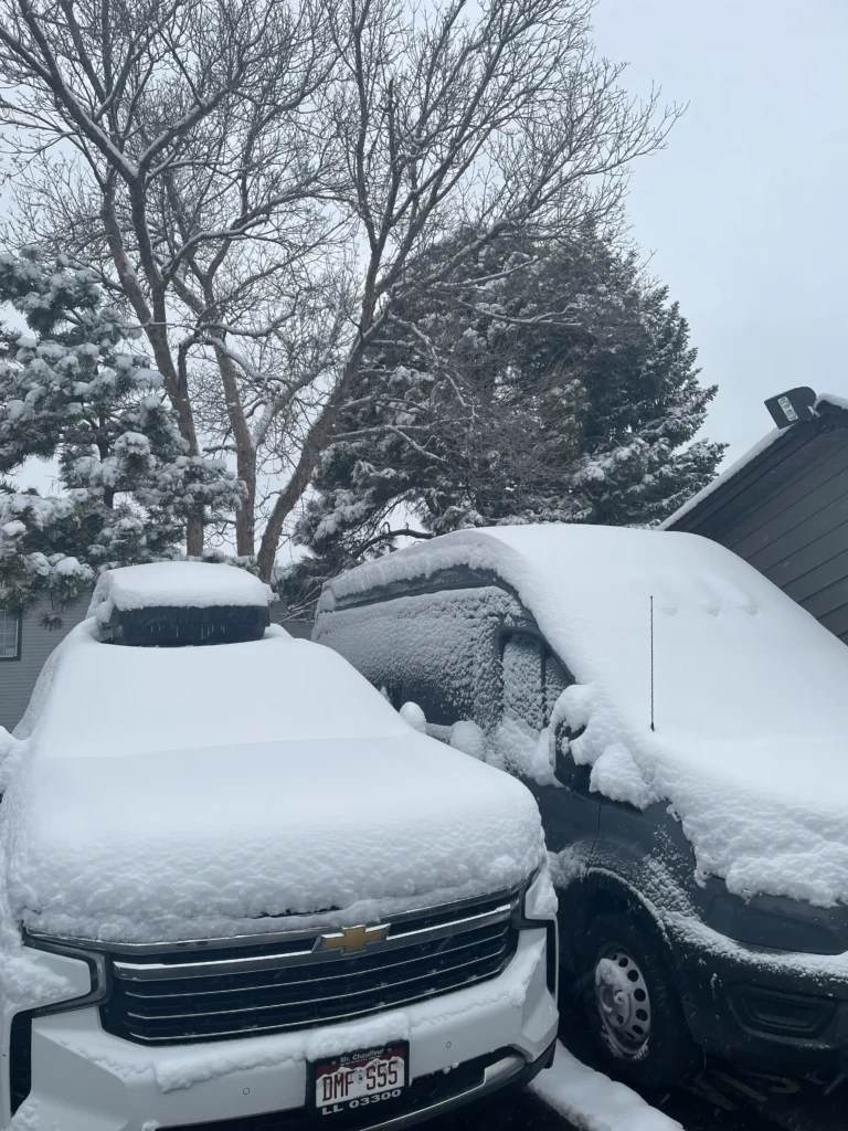 Snow-covered luxury SUV and Van. Reliable winter private car service for ski transfers by Mr. Chauffeur Colorado.