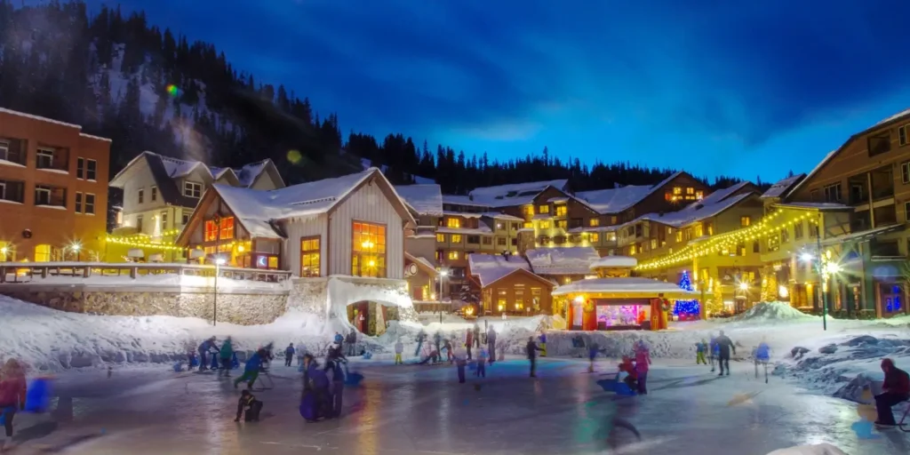 Winter Park Resort village with ice rink at night. Private shuttle from Denver to Winter Park by Mr. Chauffeur Colorado.