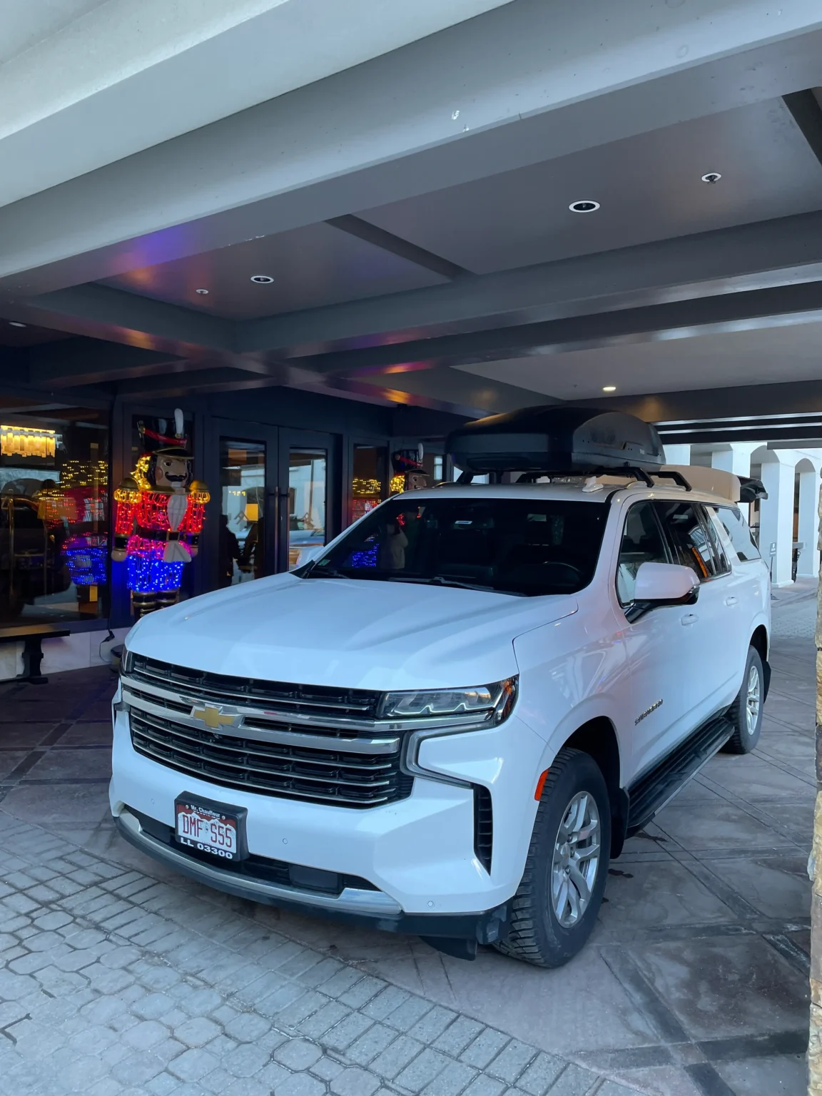 White luxury SUV at Grand Hyatt Hotel, Vail, CO. Private car service from Denver to Vail.