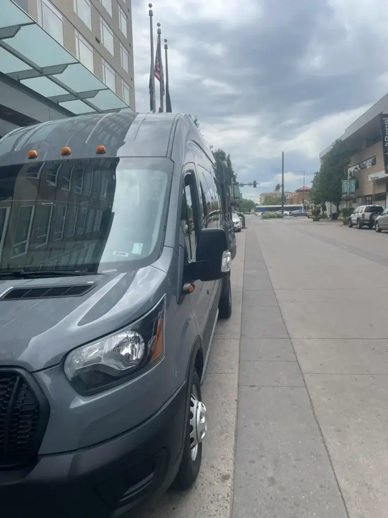 Grey luxury high-roof passenger van. Private shuttle and group van service. Mr. Chauffeur Colorado.