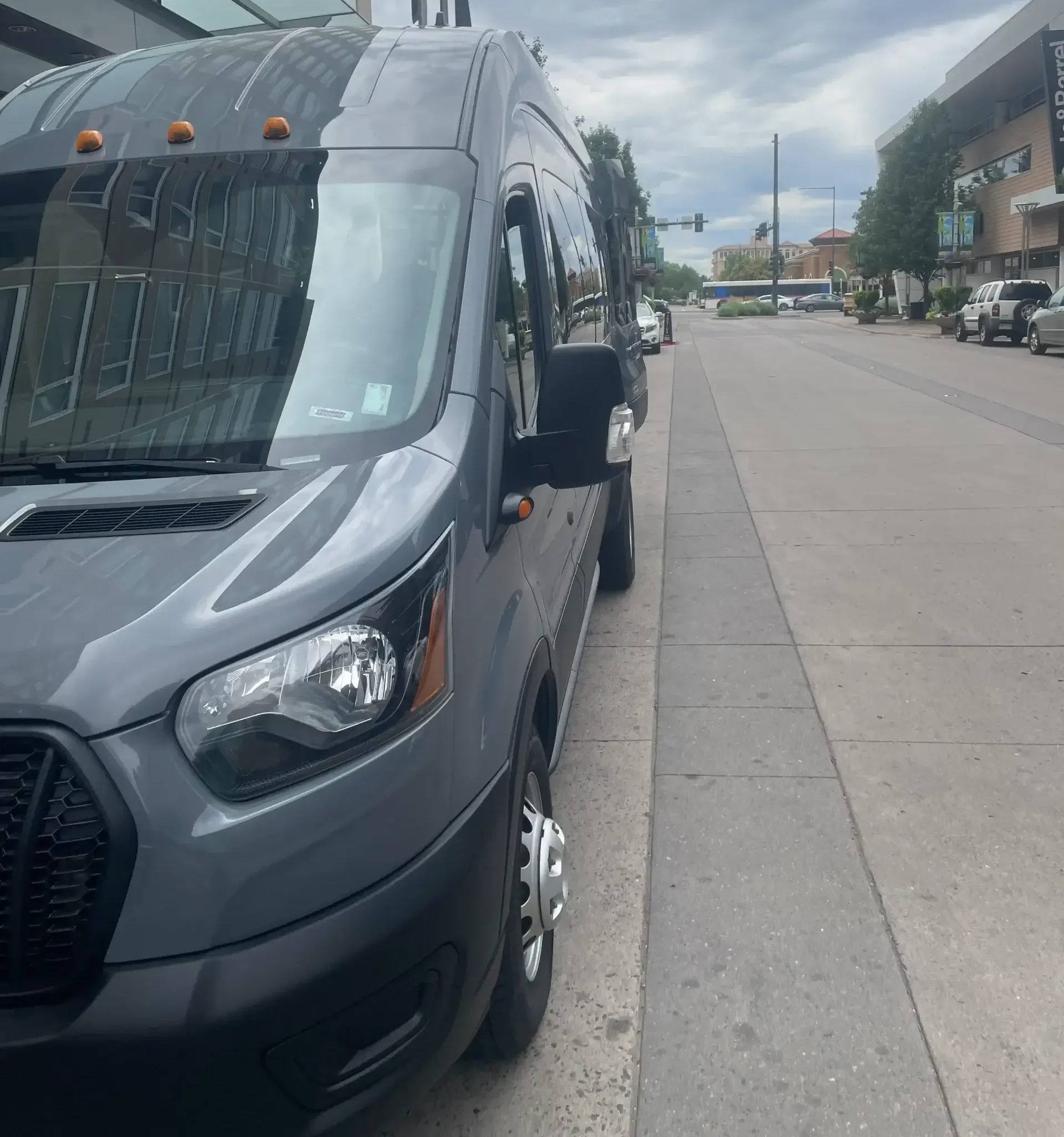 Grey luxury high-roof passenger van. Private shuttle and group van service. Mr. Chauffeur Colorado.