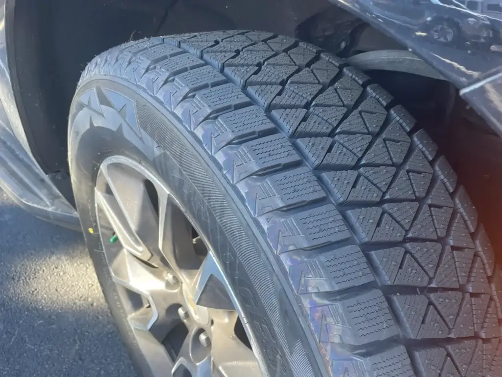 Close-up of professional winter tires on a luxury SUV. Safe and reliable mountain transportation.