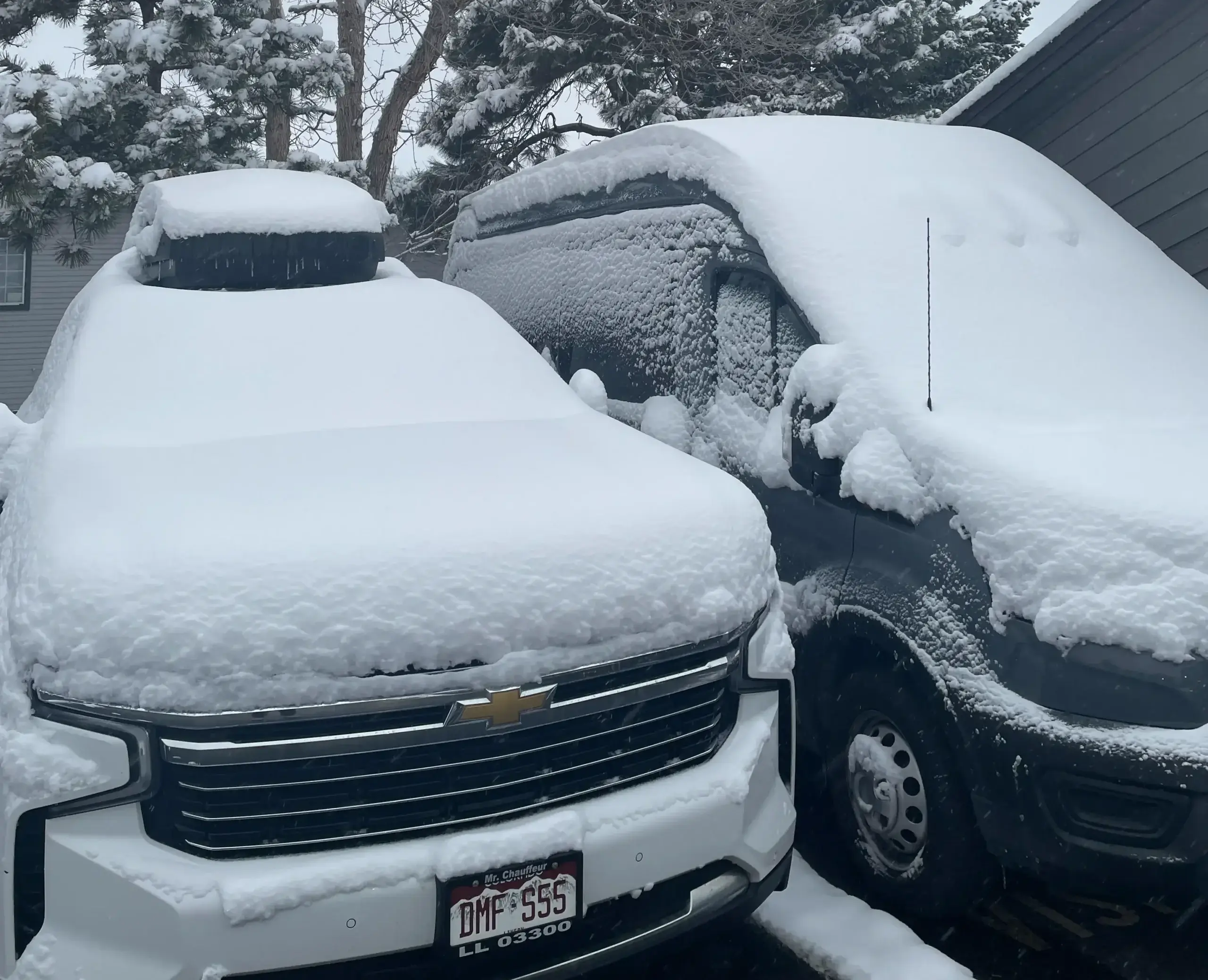 Snow-covered luxury SUV and Van. Reliable winter private car service for ski transfers by Mr. Chauffeur Colorado.